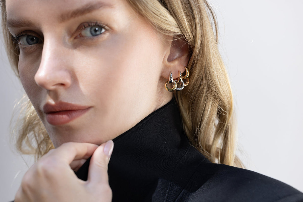 model wearing signature tapered hoops double stacked for two-tone wearability