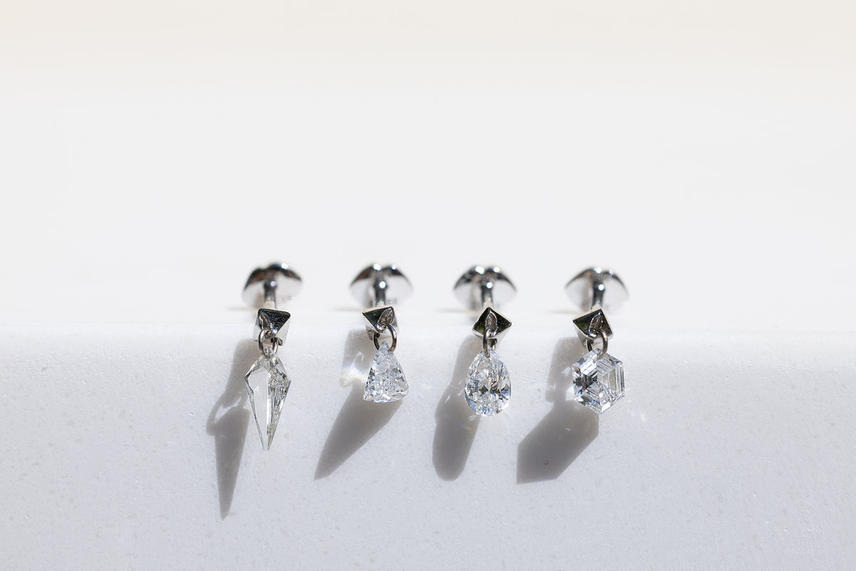 kite, trillion, pear, and hexagon diamond dangle studs with lip motif flat back