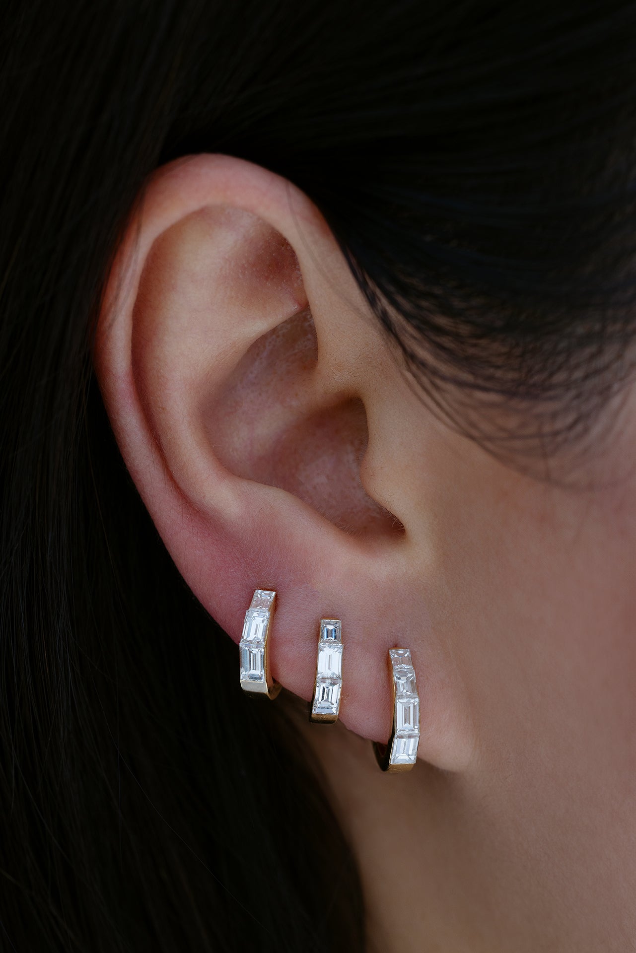 18k yellow gold baguette diamond tapered hoops in size 6.5mm, 8mm, and 9.5mm