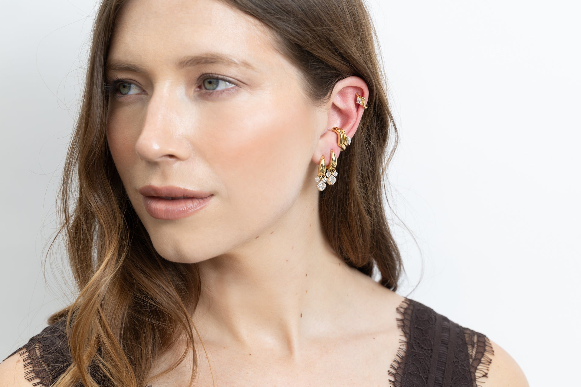 model wearing 18k yellow gold trapeze hoops in size classic, medium, and small