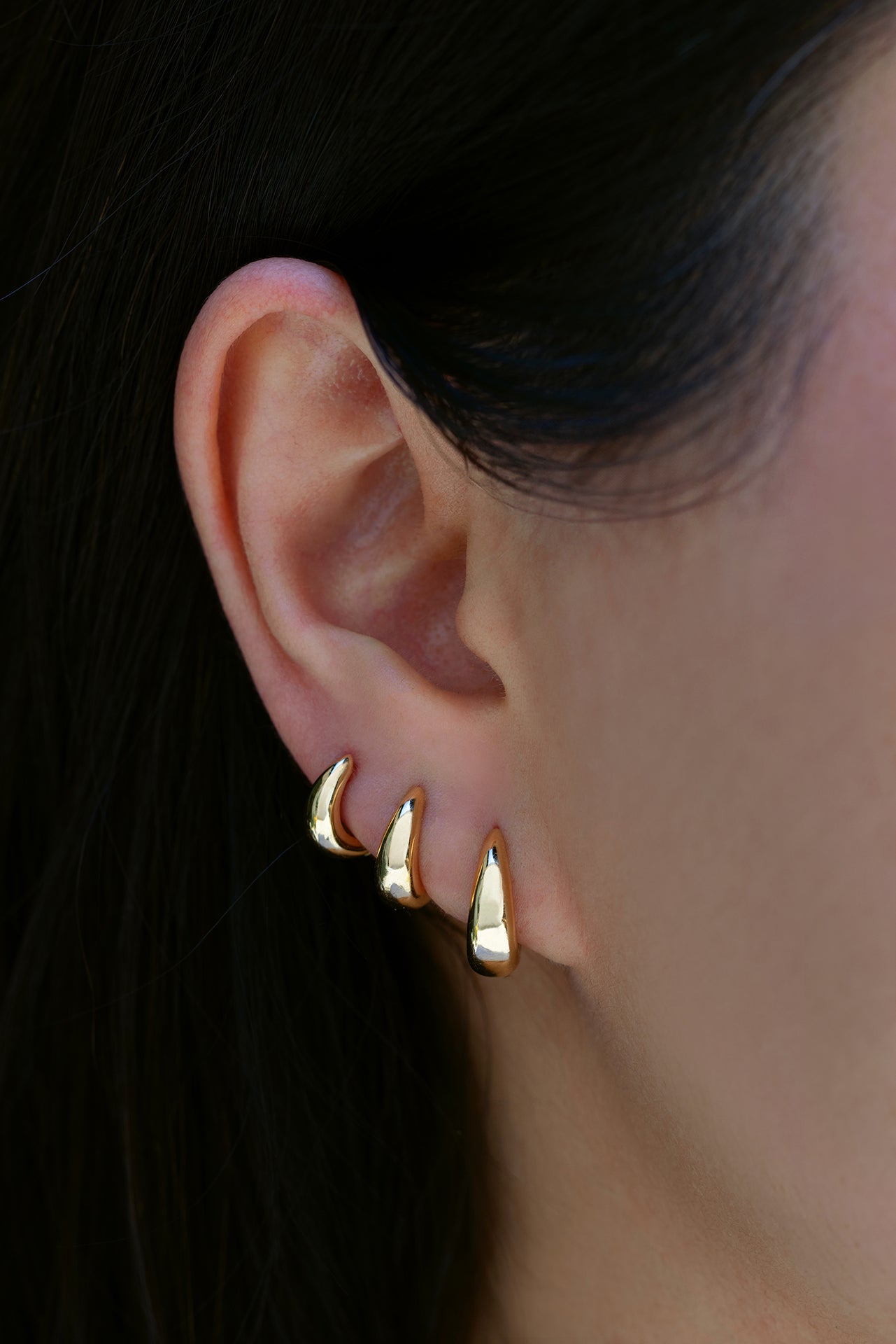 18k yellow gold signature tapered hoops in size 6.5mm, 8mm, 9.5mm