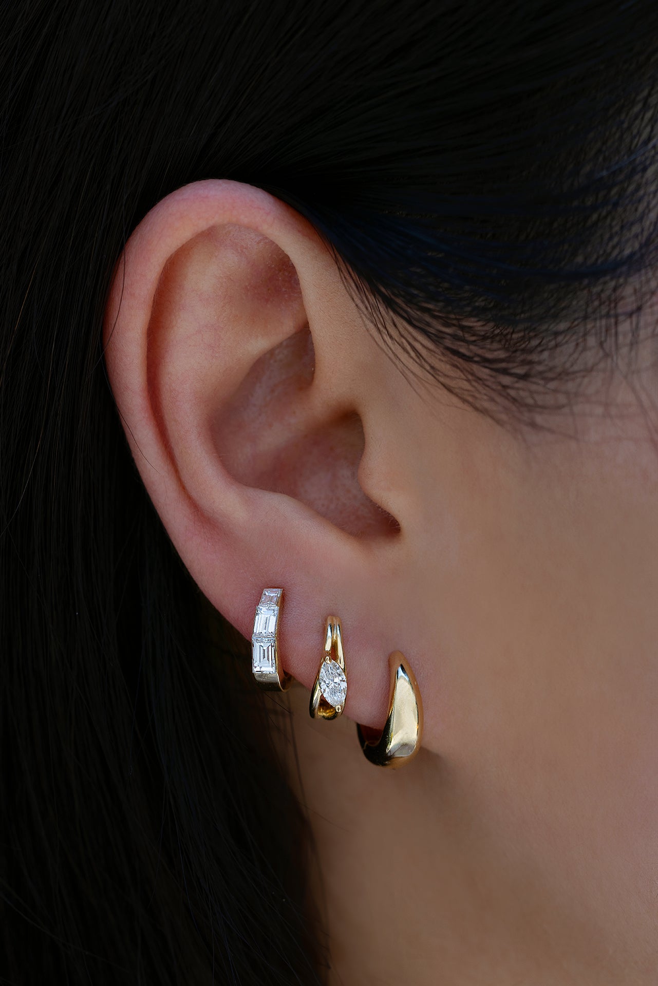 18k yellow gold 9.5mm signatured tapered hoop, 18k yellow gold 9.5mm hoop with diagonal marquise diamond center, 18k yellow gold 8mm baguette diamond tapered hoop