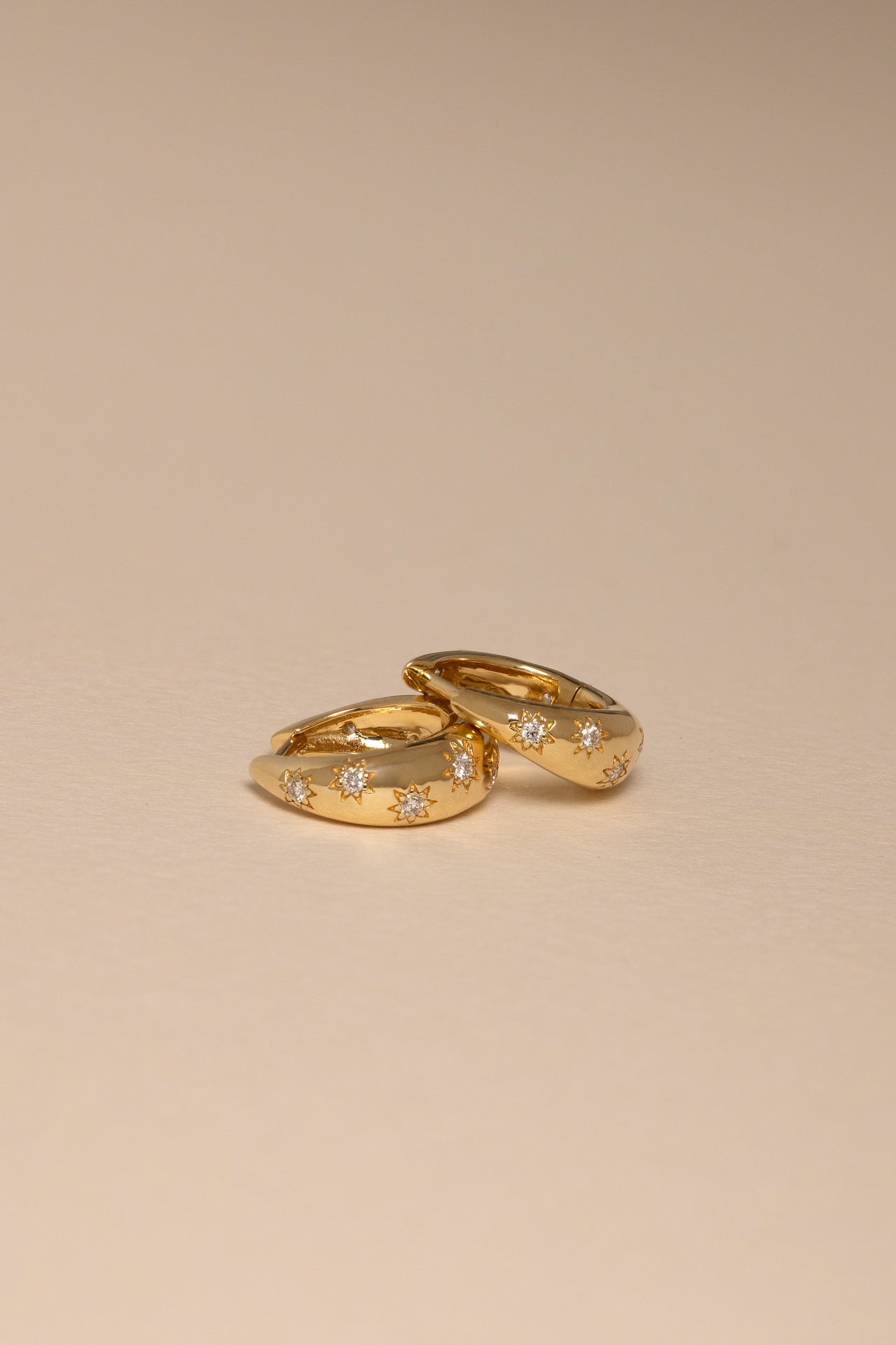 18k yellow gold 9.5mm tapered hoops with star detail with round diamonds