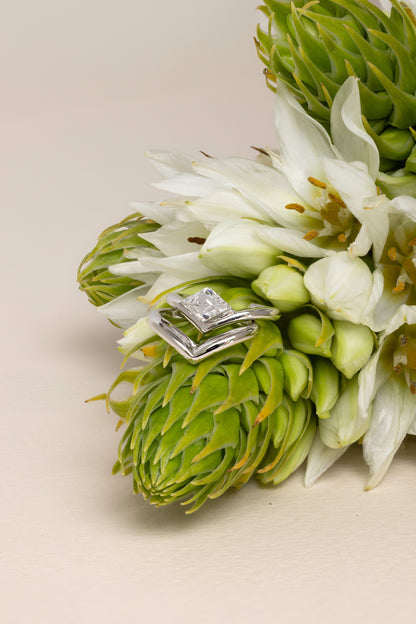 18k white gold V shaped ear cuff with lozenge step-cut diamond next to  18k white gold V shaped ear cuff