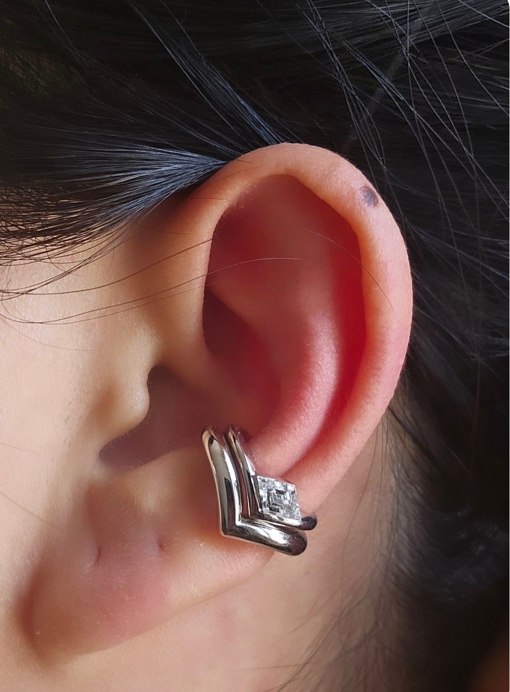 18k white gold V shaped ear cuff with lozenge step-cut diamond stacked above 18k white gold bold V shaped ear cuff